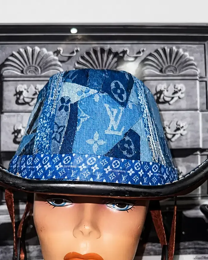 Large patchwork denim cowboy helmet with a crystal-studded brim band and brown leather chin straps