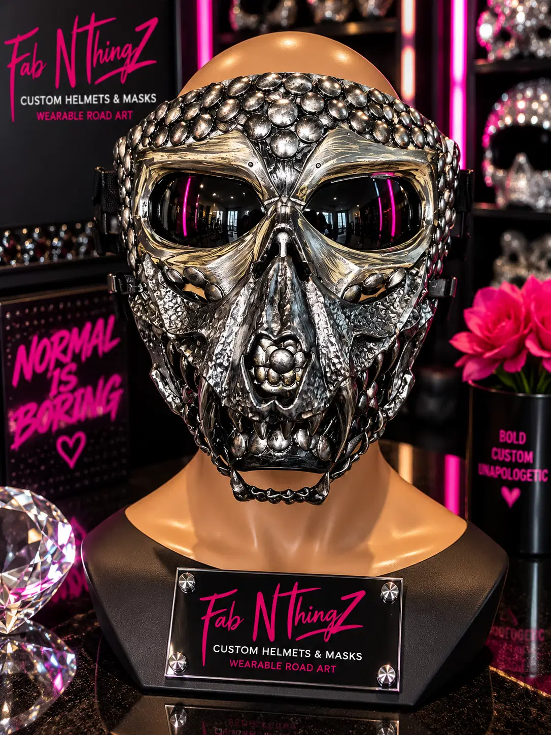 Gunmetal two-face skull mask with layered metal plating, studded detailing, and dark lenses on a mannequin