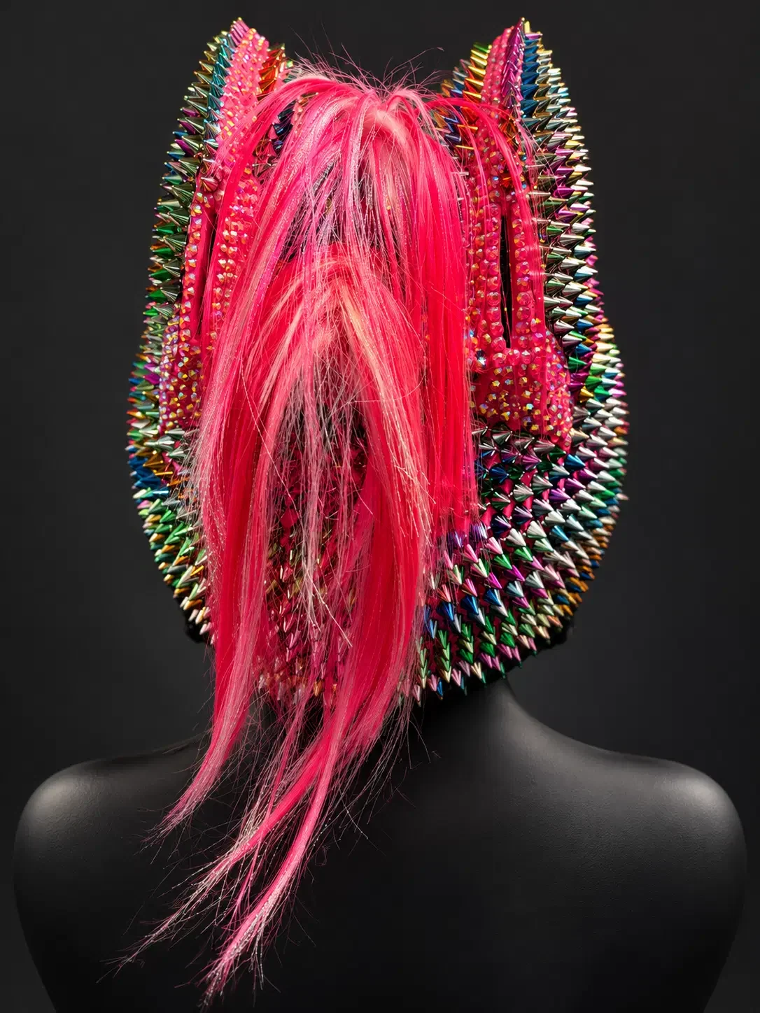 Back view of the Rainbow Cat Ear Spiked Mohawk Helmet showing the pink mohawk and rainbow chrome spikes on a mannequin bust